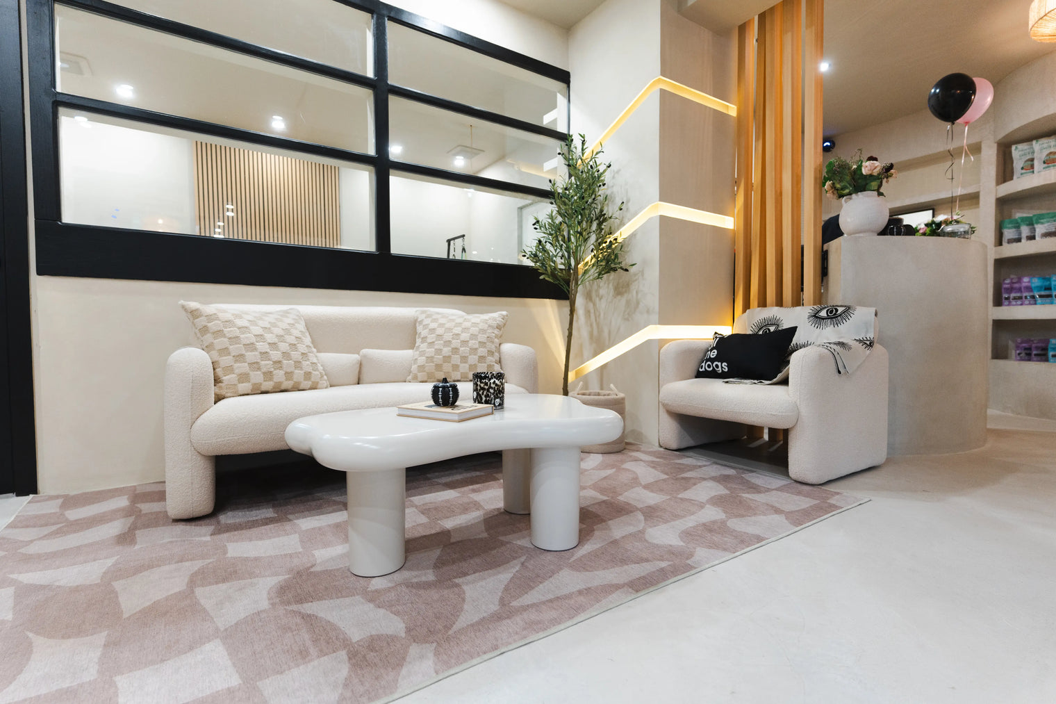 Modern dog daycare lounge in Montreal with cozy seating, decorative pillows, and boutique-style interior design